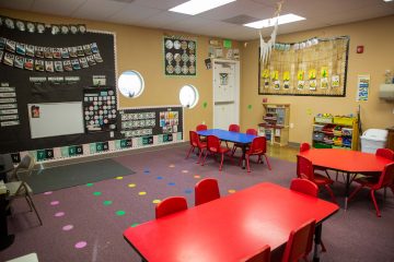Brighten Academy Preschool classroom with red kids tables