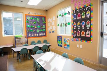 Brighten Academy Preschool classroom with tables and a student art gallery on the wall