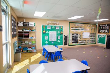 Brightly decorated Brighten Academy classroom with tables and educational materials on the walls