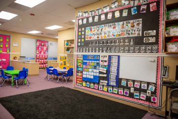 Circle time area of a Brighten Academy Preschool classroom with learning materials decorating the walls