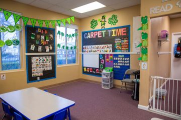 Colorfully decorated carpet time area of a Brighten Academy Preschool classroom